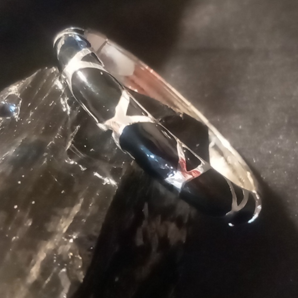 Talbot's cross cross black enamel over silver spring hinged bangle bracelet.
